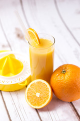 Fresh orange juice in glass with sliced orange