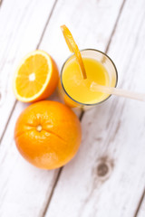 Fresh orange juice in glass with sliced orange