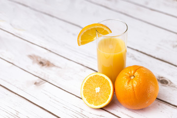 Fresh orange juice in glass with sliced orange