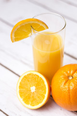 Fresh orange juice in glass with sliced orange