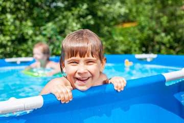 Happy child in a swimming pool outdoors