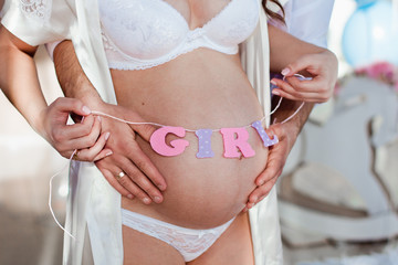 a pregnant woman labeled the girl belly in white underwear