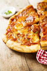 Meat pizza with cheese and herbs