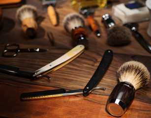 Shaving accessories on a luxury wooden background.