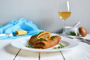 Delicate pancake stuffed with mushrooms and cheese
