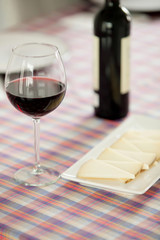 Glasses of red wine and cheese tray
