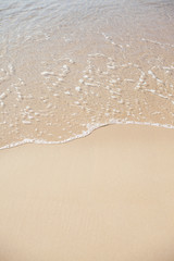 Sanfte Meereswelle am Sandstrand