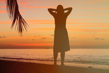 woman enjoy sunset at tropical beach
