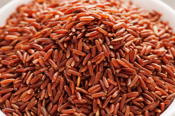 Red rice in white ceramic bowl close-up