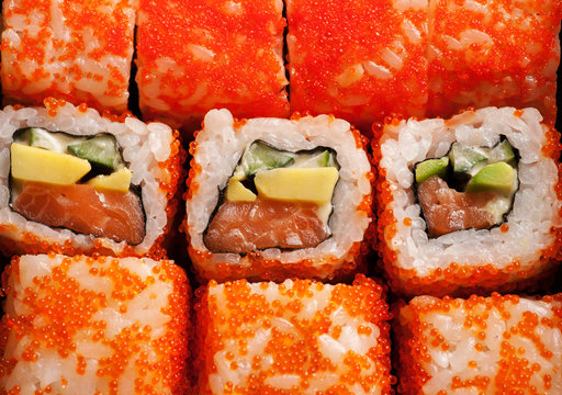 Sushi rolls with salmon, cheese and red caviar