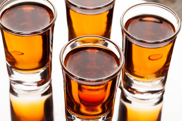 Cold drink with ice in glass on wooden table, selective focus
