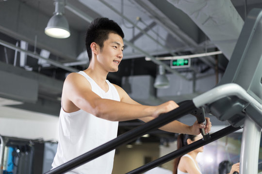 young man working out in modern gym