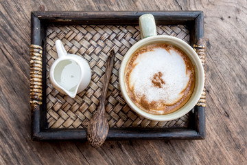  cappuccino coffee cup with mini jar of syrup and wooden spoon a