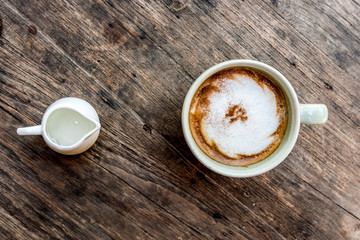  cappuccino coffee cup with mini jar of syrup and wooden spoon a