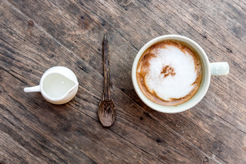  cappuccino coffee cup with mini jar of syrup and wooden spoon a