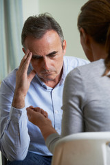 Depressed Mature Man Talking To Counsellor