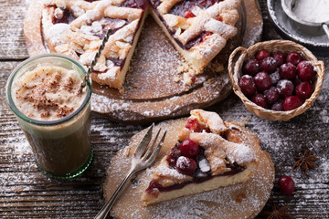 Delicious cake with cherries, icing sugar and a cup of coffee