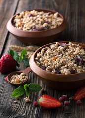 Healthy breakfast of muesli with strawberries, berries, milk and