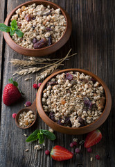 Healthy breakfast of muesli with strawberries, berries, milk and