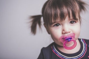 Portrait of a 2 year old girl isolated on white background