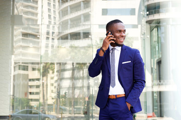 Happy young african american businessman with cell phone