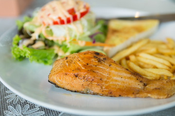 grilled salmon steak serving with vegetable salad