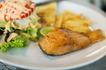 grilled salmon steak serving with vegetable salad