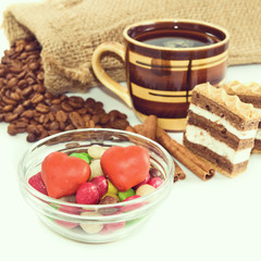 image of a cup of coffee and various sweets closeup