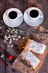 Strudel or pie with cranberries and cheese and two cups of coffee