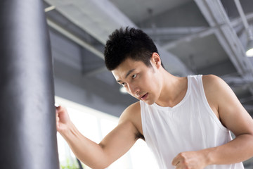 Fototapeta na wymiar young man working out in modern gym