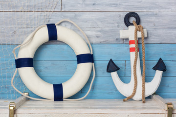 Anchor and life buoy on wood background blue-white