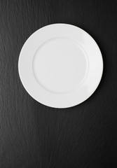 Empty white plate on stone background Top view