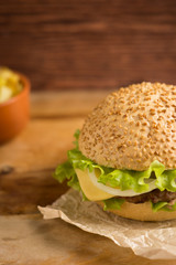 Burger on the brown wooden background
