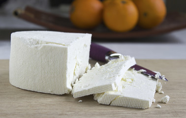 White feta cheese  on a wooden cutting board