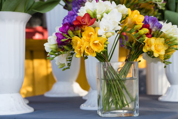 Bright colored flowers in a transparent vase with water