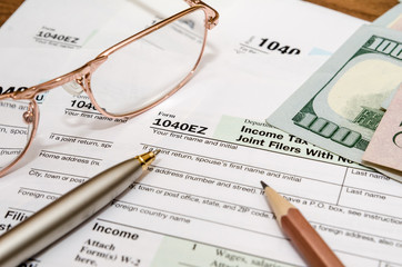 USA tax form 1040EZ for year 2016 with pen and glasses