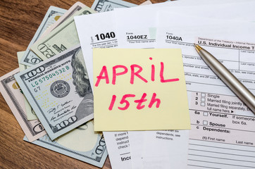 Official USA tax form 1040, calculator, pen and dollar and the day tax april 15