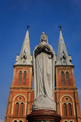 Virgin Mary with background Church's twin tower in Vietnam