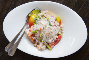 Thai spicy glass noodle salad with seafood on the plate