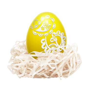 Yellow easter egg in nest isolated on the white