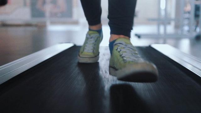 running on a treadmill in a gym close up feet