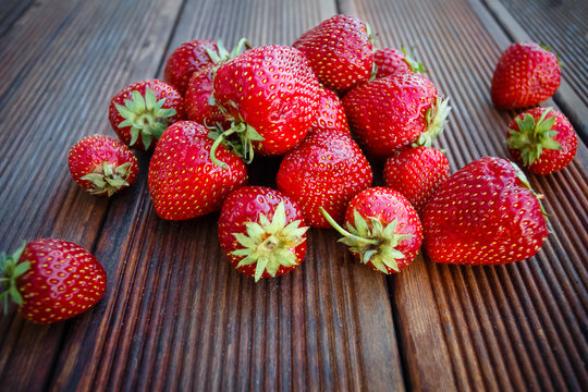Fresh garden strawberries on old wooden background