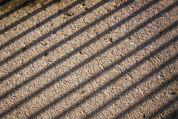 A photograph of railing shadows cast on the floor