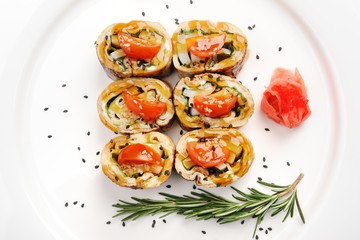 Japan omelette rolls with tomatoes served with ginger, black ses