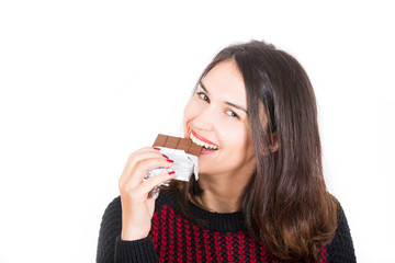 young woman eating chocolate isolated on white