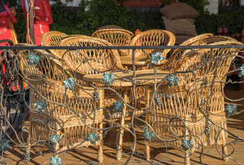 wicker chairs and table in sunny day outdoors
