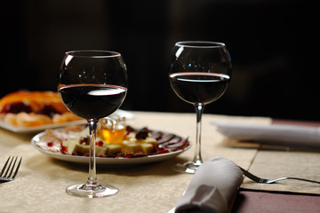 two glasses of red wine on the background of the dishes in the r