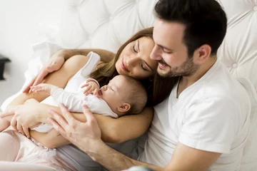 Fototapeten Happy family with newborn baby © BGStock72