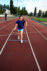 Fototapeta premium Little girl have fun on the stadium