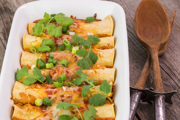 Casserole dish with mexican food - beef enchiladas.